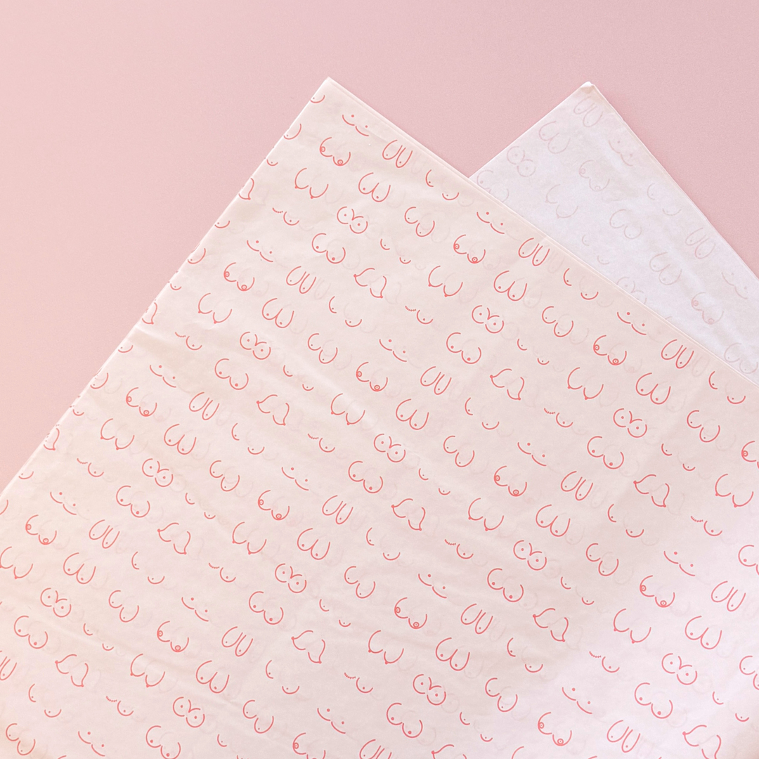 [main] Light Pink tissue paper featuring hot pink shapes of different boobs across the tissue paper to represent breastfeeding. 