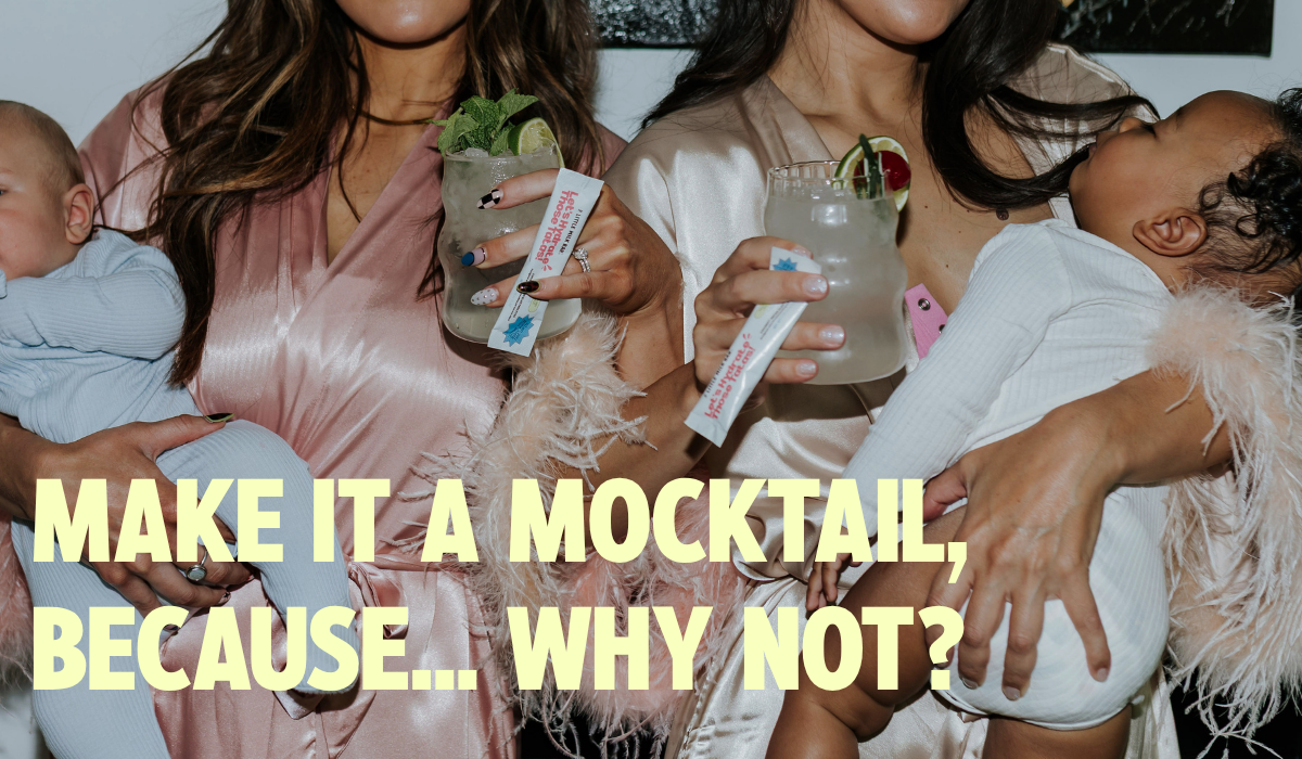 Two moms toasting electrolyte mocktails with garnish while holding Let's Hydrate Those Tatas coconut water drink mix sticks