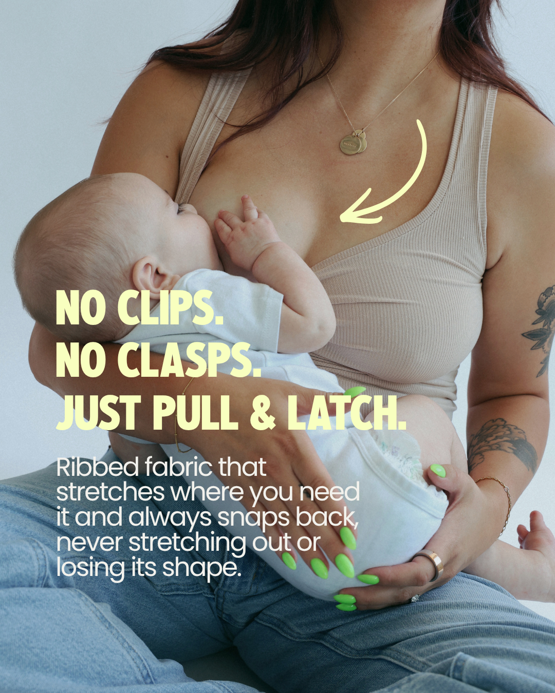 Mom breastfeeding her baby in the Frankie Tank, a nursing tank with no clips or clasps — just pull the neckline down and latch