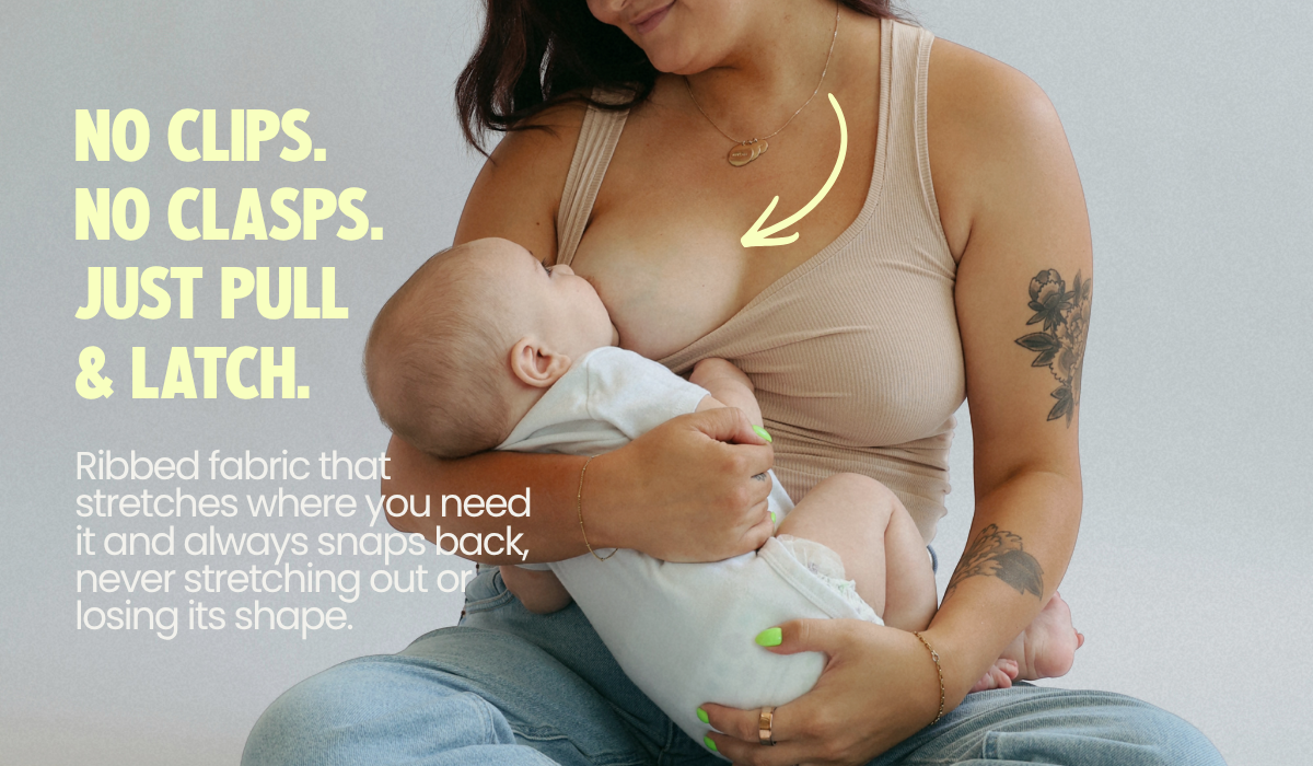 Mom breastfeeding her baby in the Frankie Tank, a nursing tank with no clips or clasps — just pull the neckline down and latch