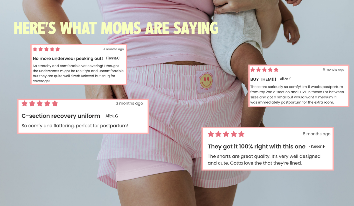 Mom holding her baby in the pink Postpartum Boxer Shorts with five-star customer reviews calling them a C-section recovery uniform with no underwear peeking out from the little milk bar
