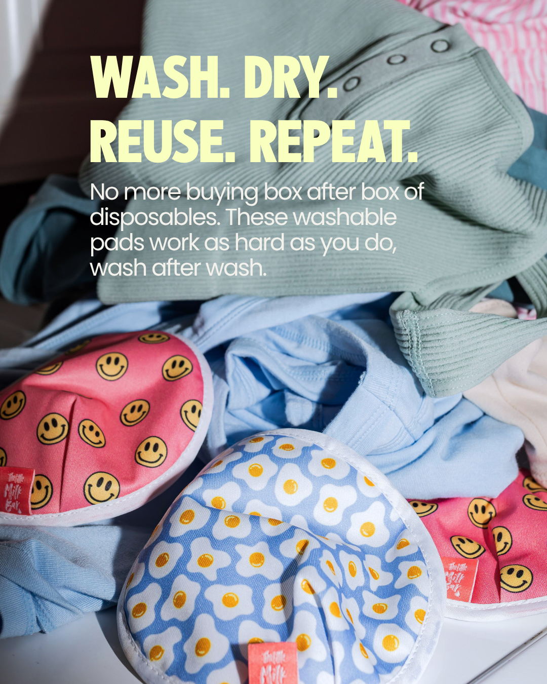 Reusable washable nursing pads in smiley face and egg prints in a laundry pile — an eco-friendly alternative to disposable nursing pads